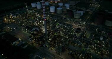 Aerial view of oil gas fuel refinery production factory at night video