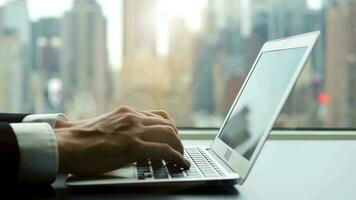 Business person working on laptop computer in modern city office worplace video