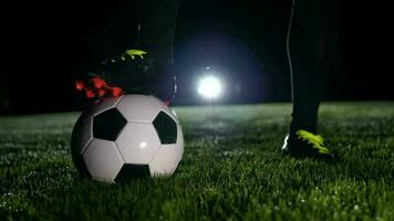 Sports person training with soccer ball on soccer field in slow motion video