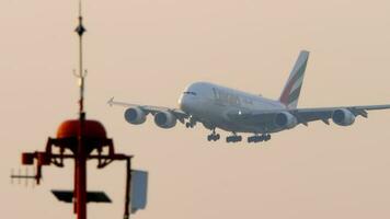 BANGKOK, THAILAND JANUARY 21, 2023 - Airbus A380 of Emirates landing at Suvarnabhumi Airport. Widebody double deck airliner flies. Cinematic shot of airplane descending. Tourism and travel concept video