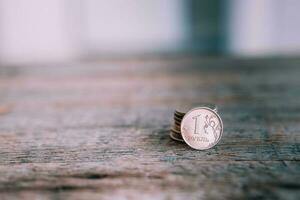 Russian  coin in denomination of one ruble on a wooden background . Copy space.  Collapse of the ruble. photo