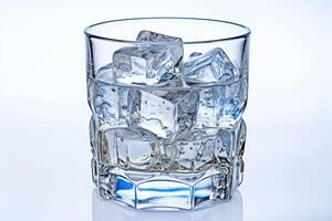 Glass of water with ice cube. . photo