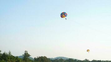 Long shot parasailing on blue sky background video