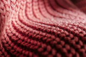 de punto textura de un rosado suéter o bufanda de cerca. foto