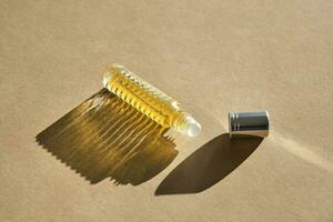 Oil roller perfume on a beige background. photo