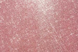 Abstract pink background with sparkles in the shape of stars. photo