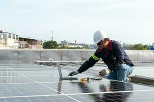 Engineer working to inspect equipment in rooftop solar power plant, solar panel maintenance installation view photo