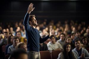 a male student raising hands at a lecture theatre with photo