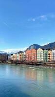 The colorful architecture of Innsbruck town with snowy mountains background in winter. video