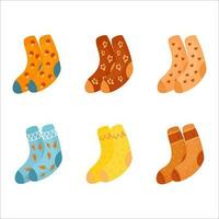 Six pairs of autumn cute socks. Warm cozy autumn, stay at home. A collection of warm multi colored flat socks isolated on a white background. vector