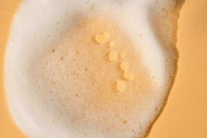 Soap foam on a light beige background. photo