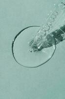 A cosmetic product flows out of a pipette with bubbles. photo