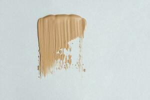 Foundation cream exture on a white background. photo