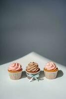 Cupcakes on a white sunny background with a shadow. photo