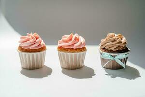 Cupcakes on a white sunny background with a shadow. photo