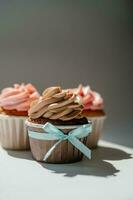 Cupcakes on a white sunny background with a shadow. photo