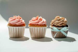 Cupcakes on a white sunny background with a shadow. photo