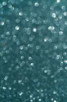 Sea wave abstract glitter background with shiny bokeh photo