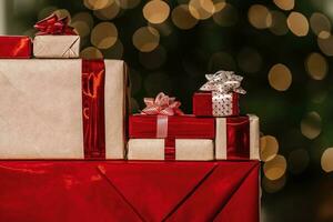 Gifts on the background of a Christmas tree with a bokeh. photo