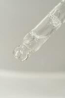 Pipette with bubbles on a white background. photo