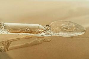 The texture of serum or oil with a pipette on a beige background. photo