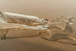 The texture of serum or oil with a pipette on a beige background. photo