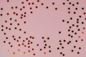 Abstract pink background with sparkles in the shape of stars. photo