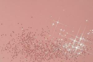 Abstract pink background with sparkles in the shape of stars. photo