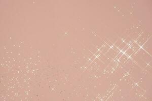 Abstract pink background with sparkles in the shape of stars. photo