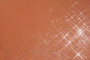 Abstract coral background with sparkles in the shape of stars. photo