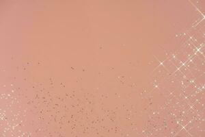 Abstract pink background with sparkles in the shape of stars. photo