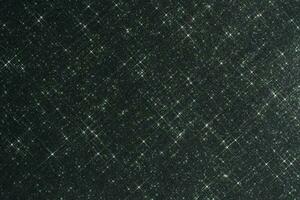 Abstract black background with sparkles in the shape of stars. photo