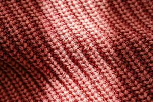 Knitted texture of a pink sweater or scarf close-up. photo