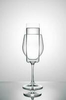 Two glasses of different shapes on a white background. photo