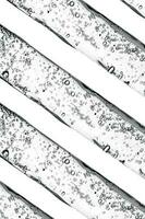 Background of cosmetic pipettes with bubbles close-up. photo