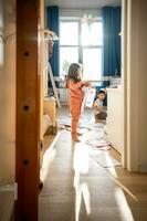 A girl among the mess and scattered sheets in the room. photo