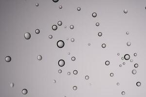 Drops of water on a transparent gray background. photo