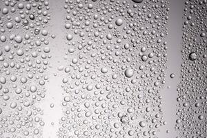 Drops of water on a transparent gray background. photo