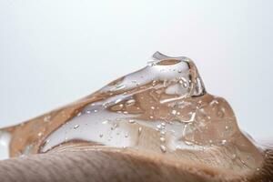 The texture of a thick cosmetic hyaluronic gel on the skin. photo