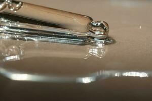 A pipette of cosmetic gel on a beige background. photo