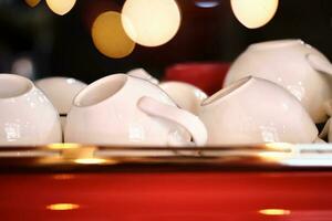 White mugs on a red coffee machine. Atmospheric photo. photo