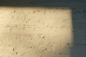 Texture of white painted brick wall close-up with sun. photo