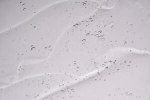 The texture of a cosmetic gel with bubbles on a white background. photo