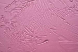 el textura de el cosmético gel en un rosado antecedentes. foto