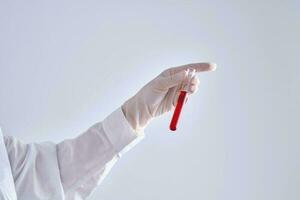 Test tube with blood in the hand. photo