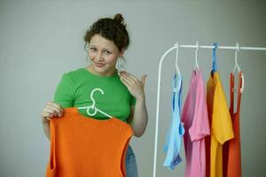 beautiful woman trying on clothes wardrobe Youth style yellow background unaltered photo