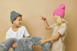 Photo of two children in hats with a teddy bear friendship Lifestyle unaltered