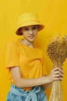 young woman a bouquet of dried flowers in hands Youth style casual wear in Hat photo