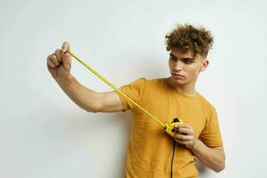 Attractive man grimace measuring tape posing isolated background photo