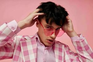 pretty man fashionable pink sunglasses jacket posing isolated background unaltered photo